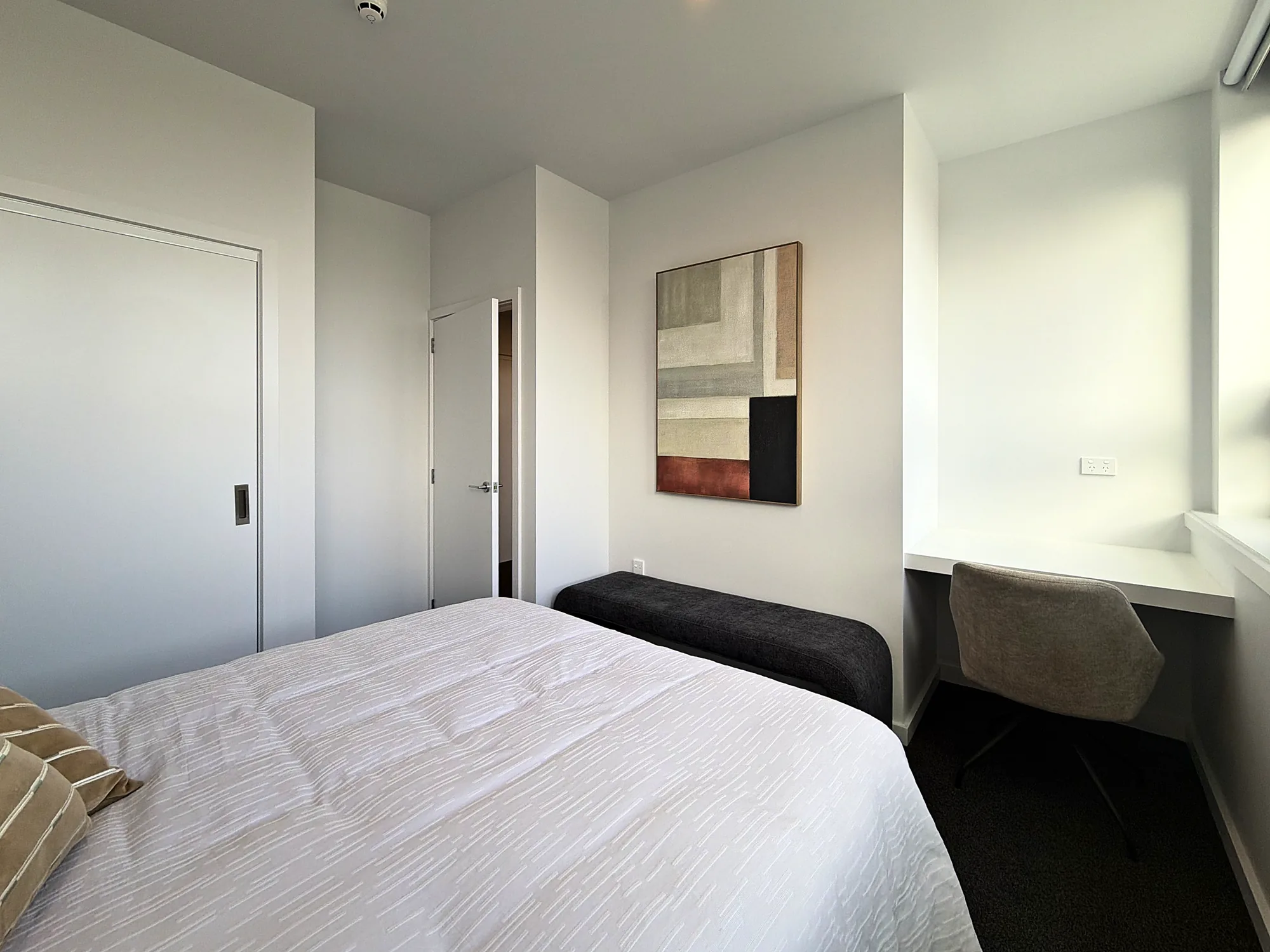Second bedroom with a desk nook in a two bedroom corner display home at Avalon Apartments, Lower Hutt
